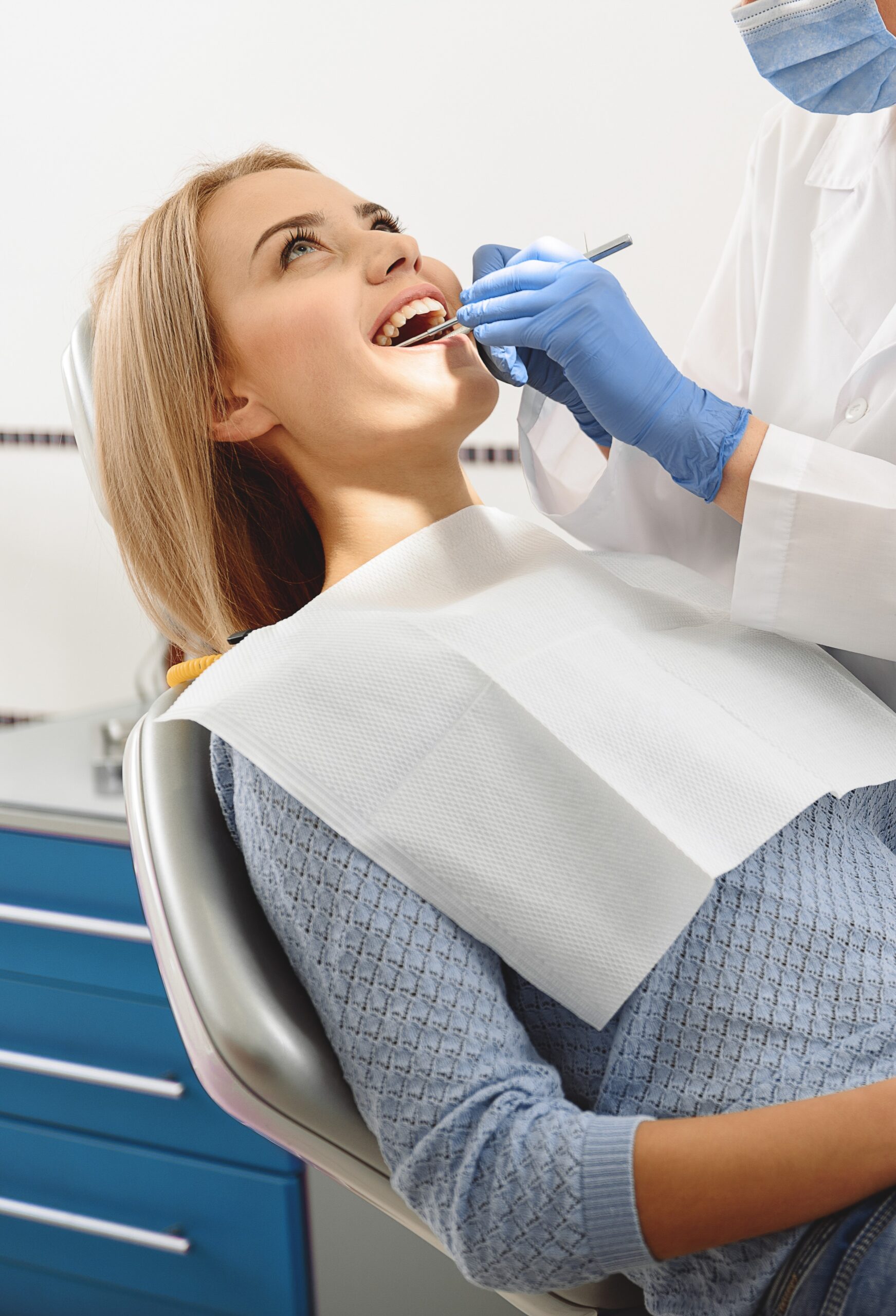 Stomatlogist working with instruments in mouth of client