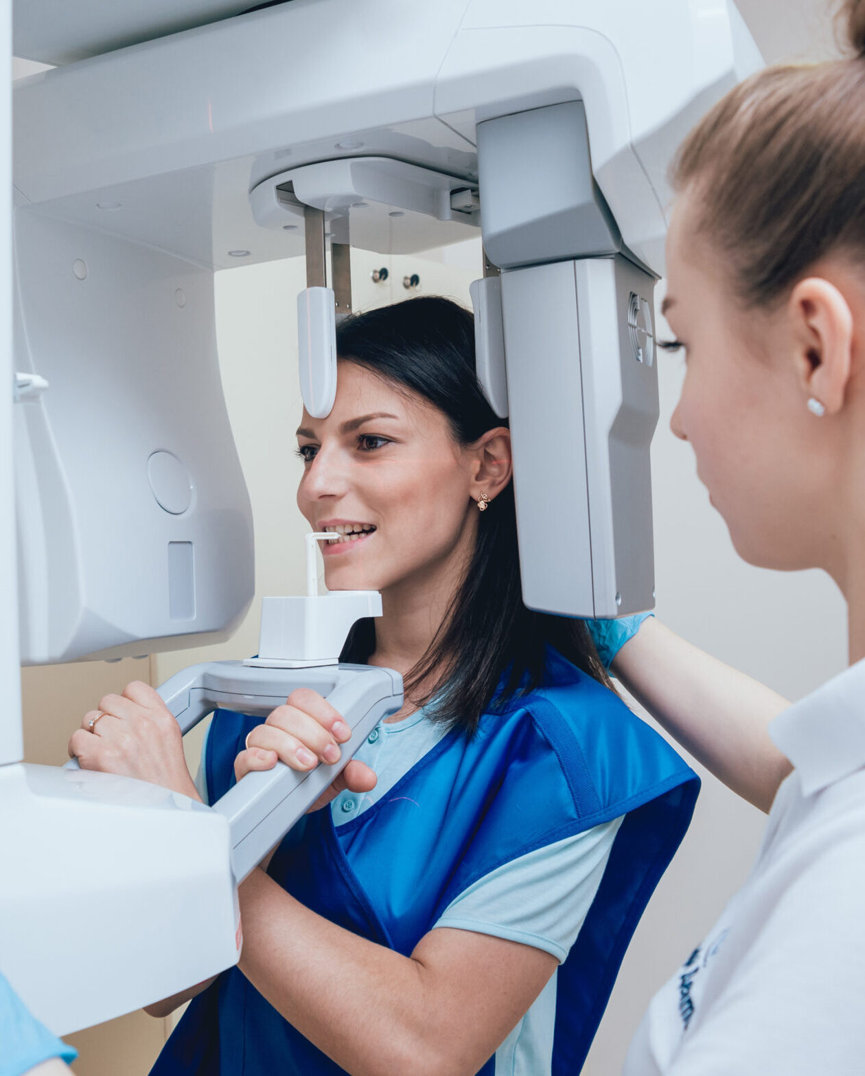 Young woman patient standing in x-ray machine. Panoramic radiography