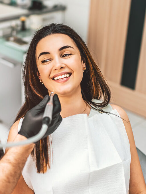Dentist working in dental clinic with patient in the chair
