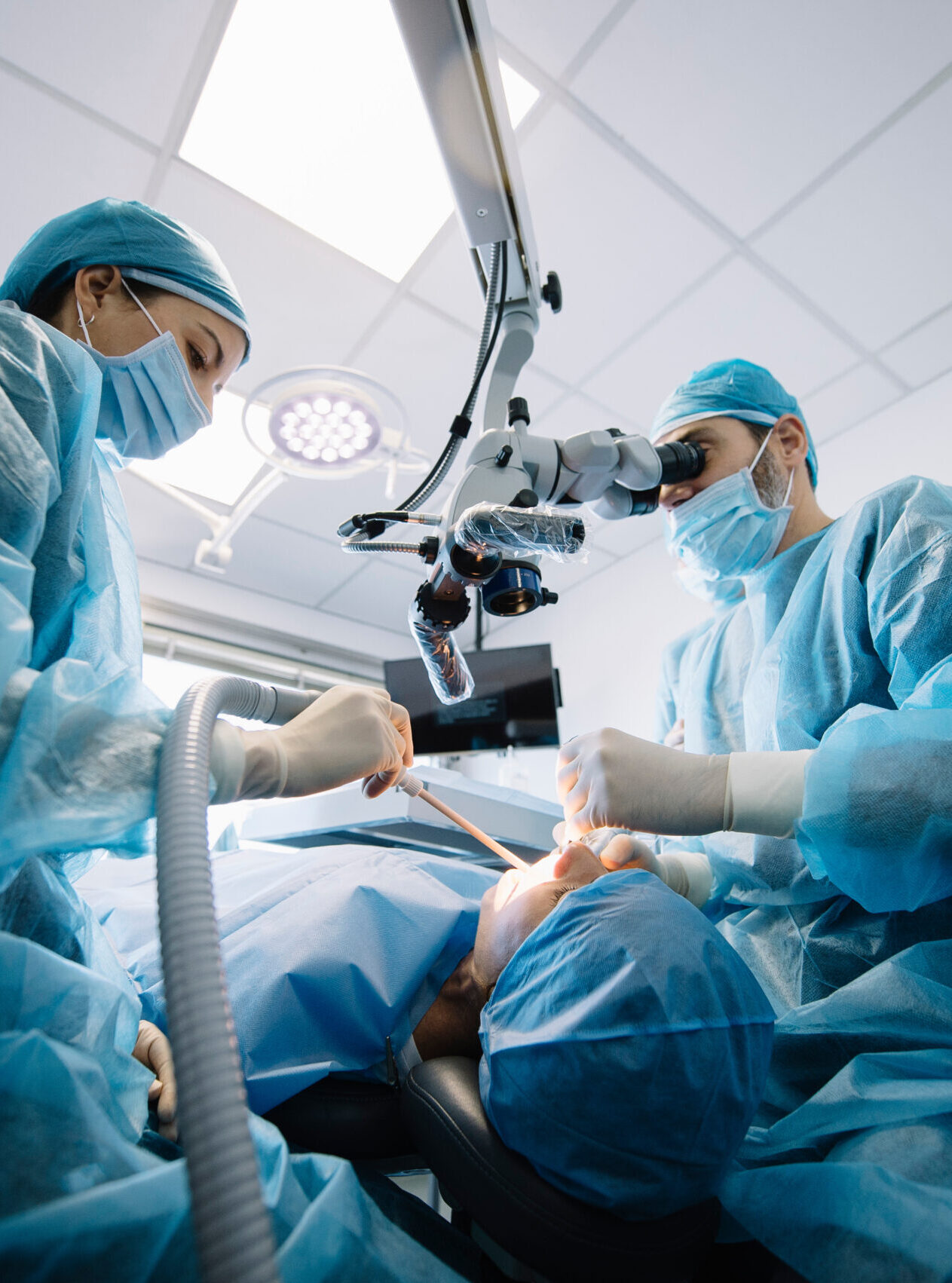 Dentist during a dental intervention with a patient. Dental clinic concept.