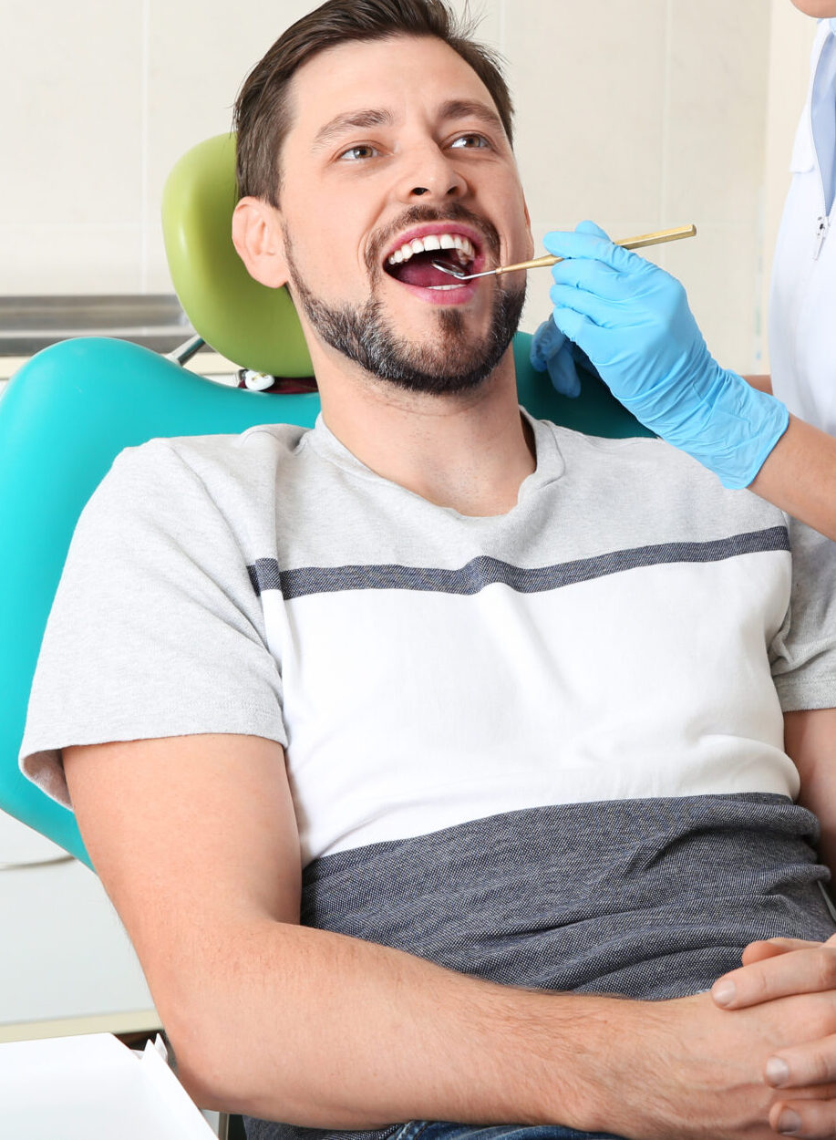 Professional dentist working with patient in modern clinic