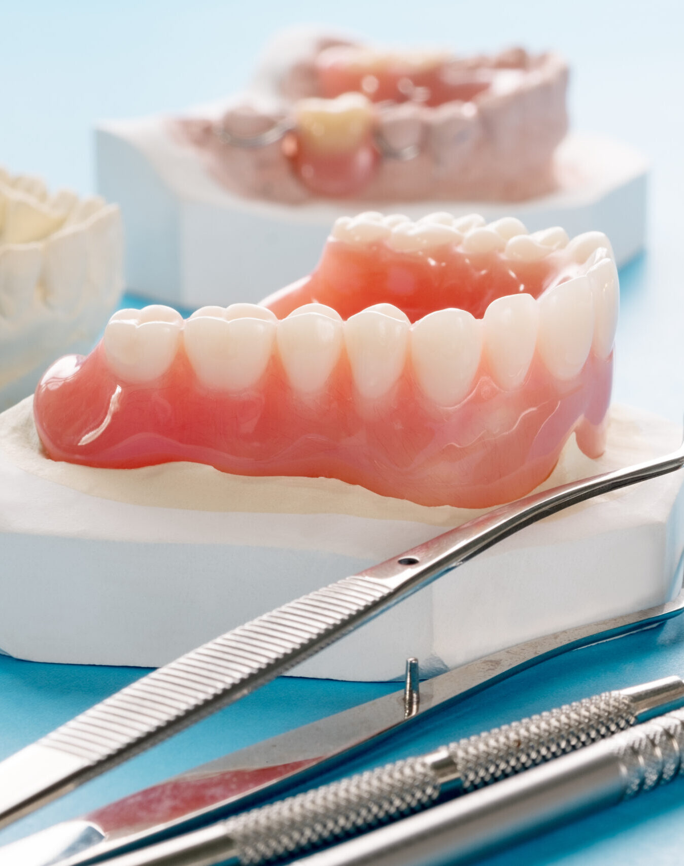 Close up , Complete denture or full denture on blue background.
