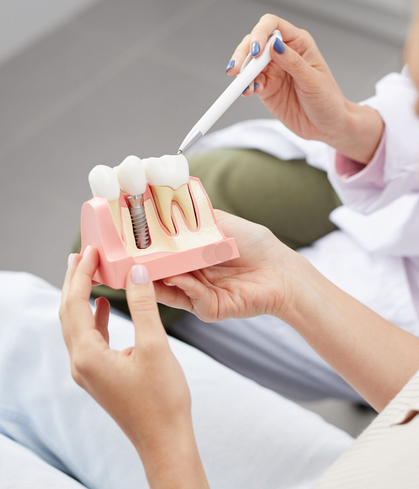 High angle view of unrecognizable young woman holding tooth model during consultation in dentists office, copy space