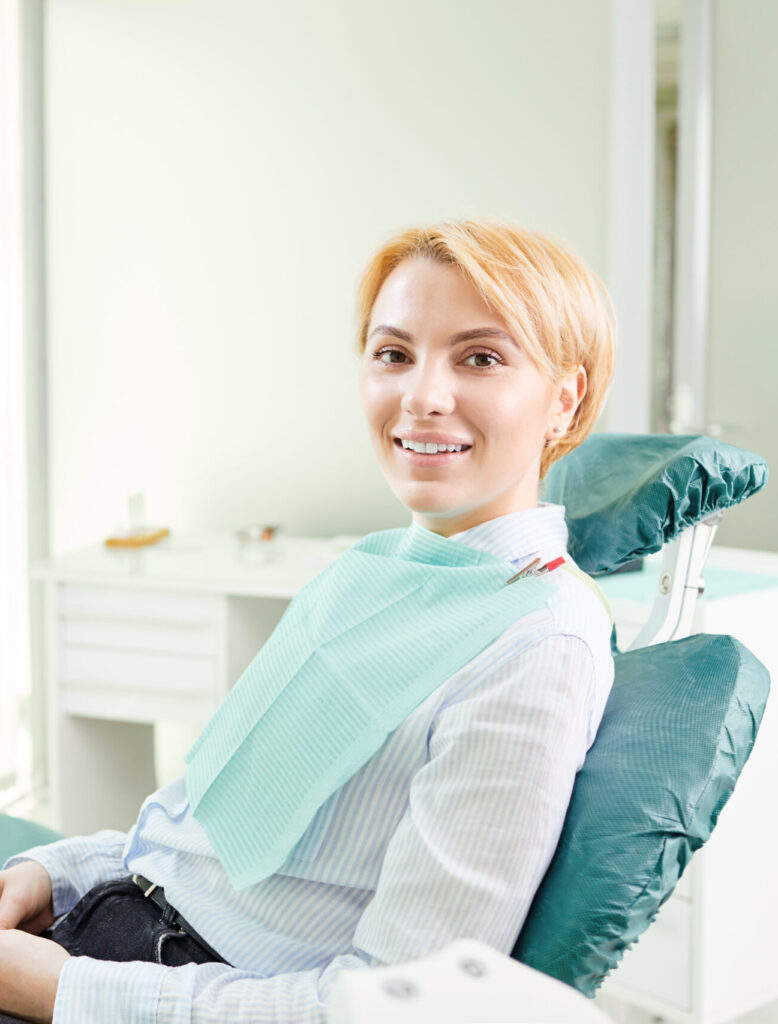 Happy girl patient in the dentist chair.