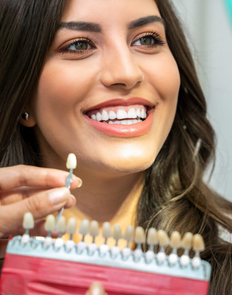 Young woman with perfect teeth , looking how white are her teeth , with teeth shade