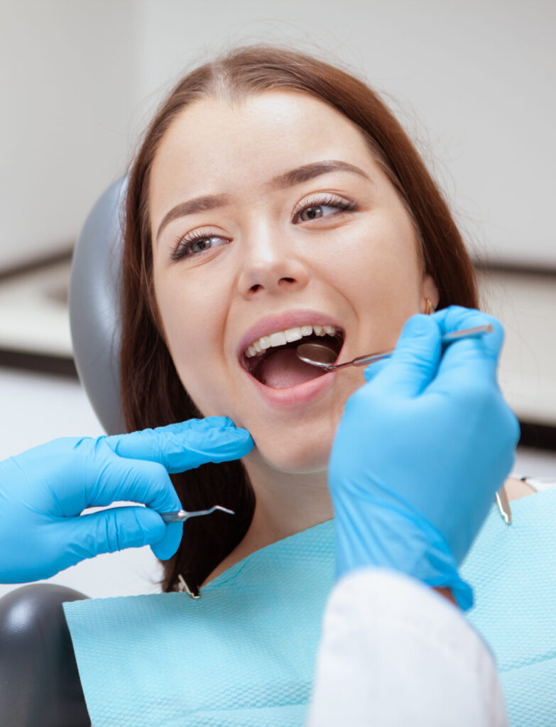 Close up of a lovely young woman having her teeth examined by dentist