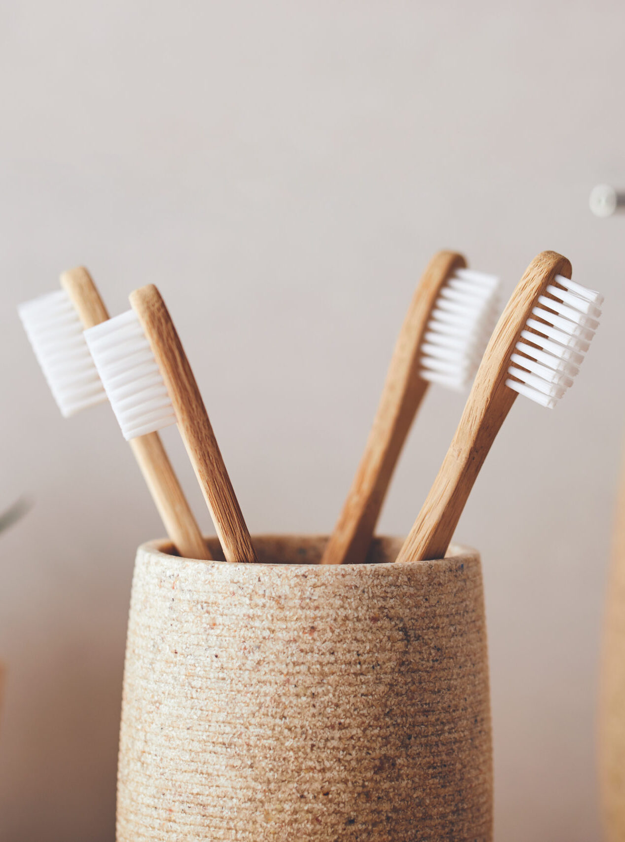 Close up of four bamboo toothbrushes in a cup