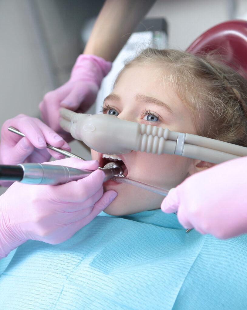 Dental treatment in a child with the use of nitrous oxide. Relaxation of the patient before surgical or dental procedures. Children's modern dentistry. The concept of healthcare. Horizontal orientation of the photo.