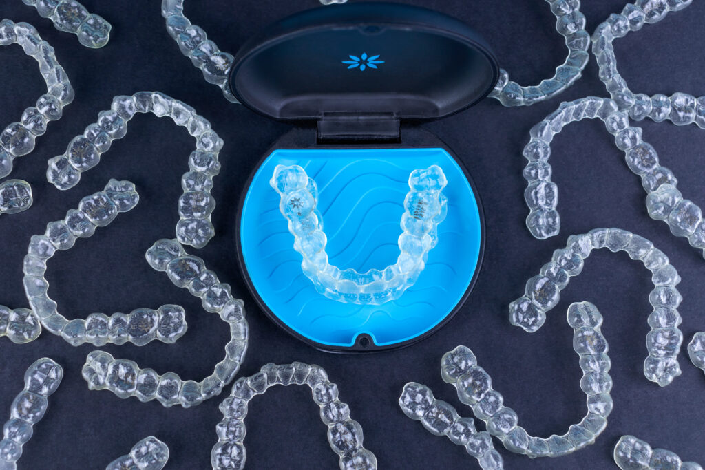 Plastic case with invisible transparent orthodontic retainers invisalign. Aligner brackets or braces dental container