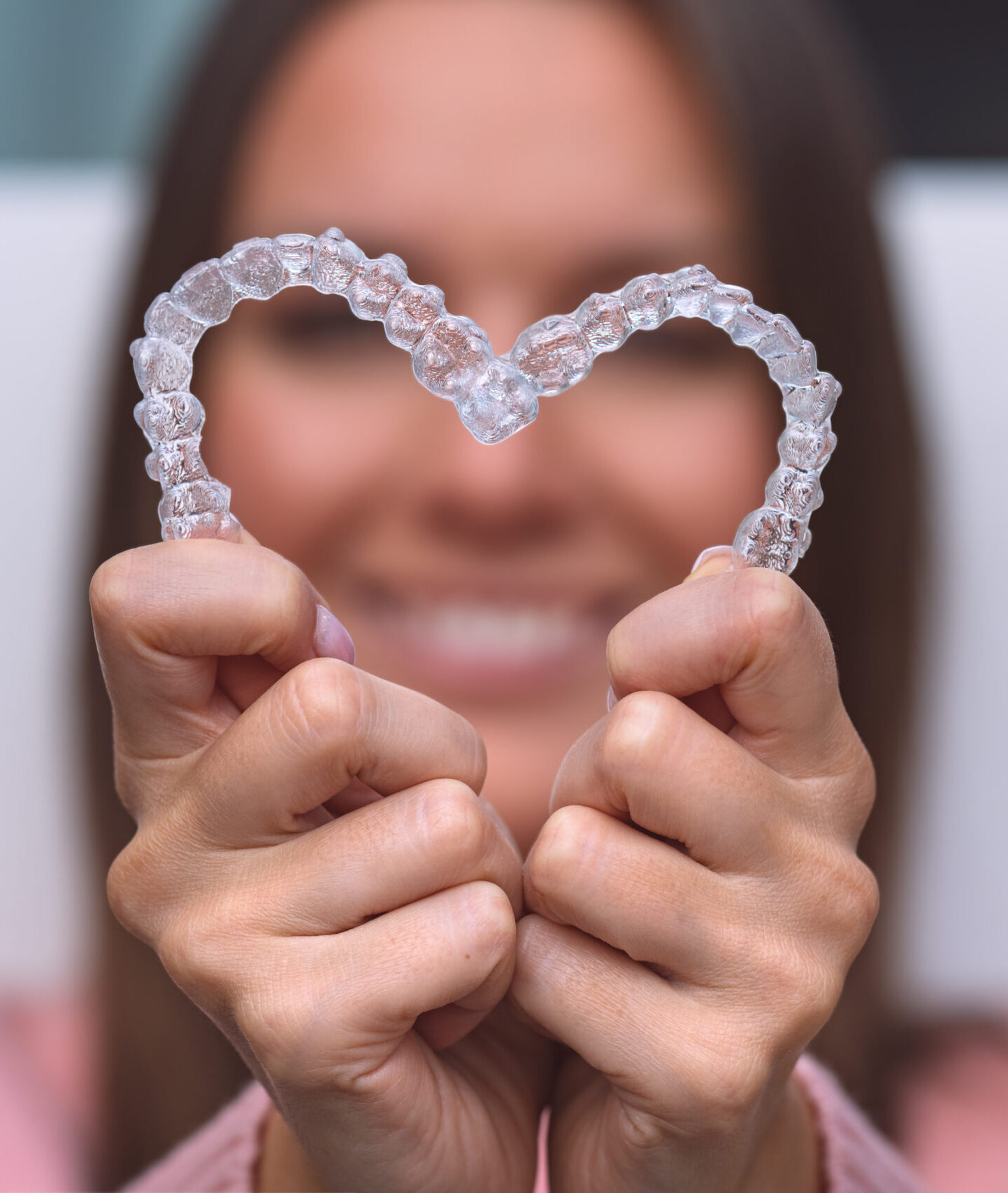 Woman with dental invisible invisalign braces or silicone trainer. Aligners treatment. High quality photo