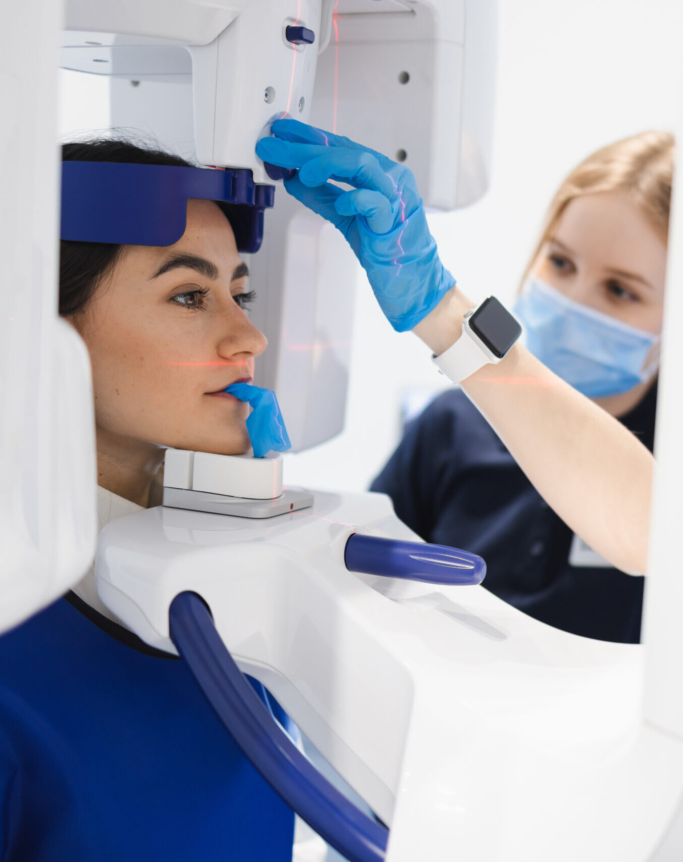 Woman makes a CT scan of the jaw. Dental assistant taking panoramic x-ray for female patient
