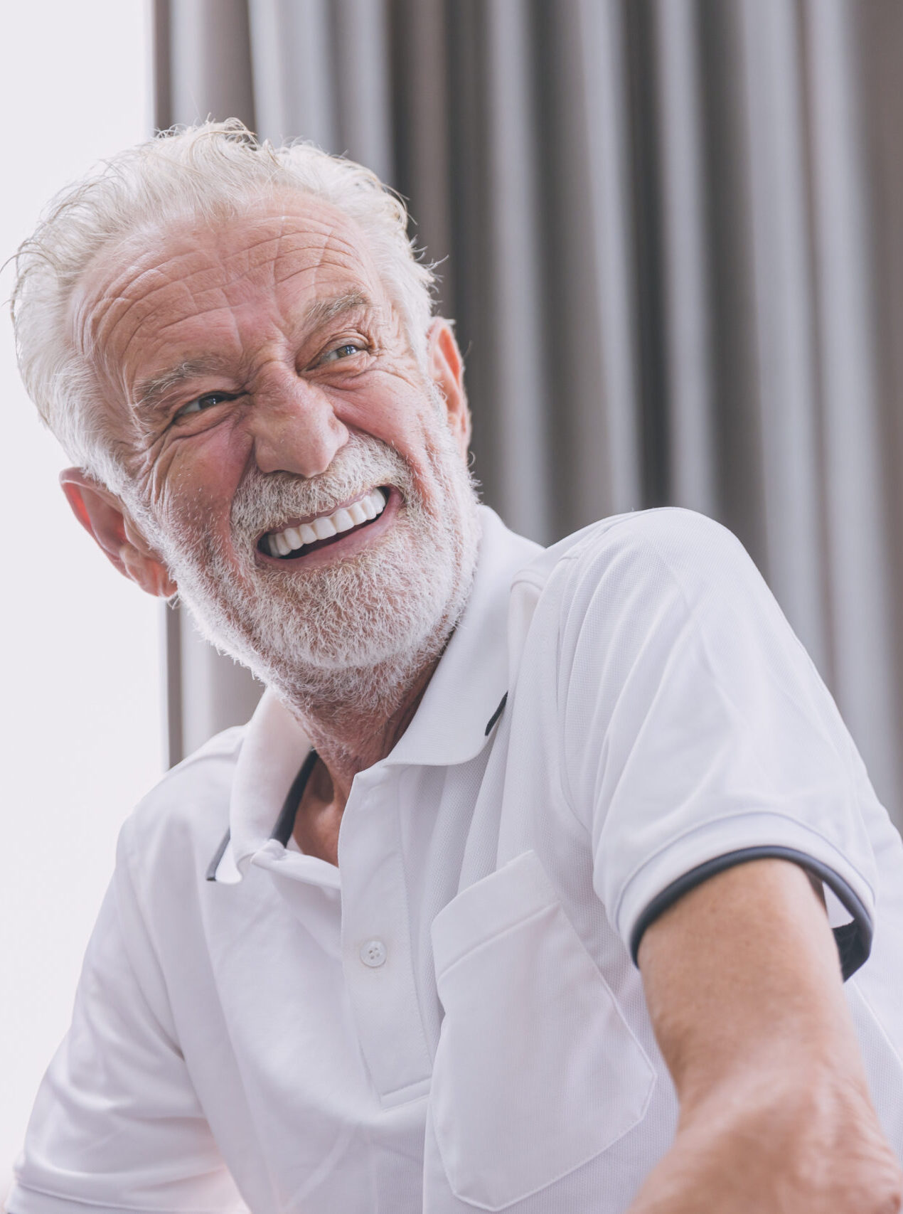 happy elderly man healthy senior confident smile with beautiful white teeth from denture prosthetics.