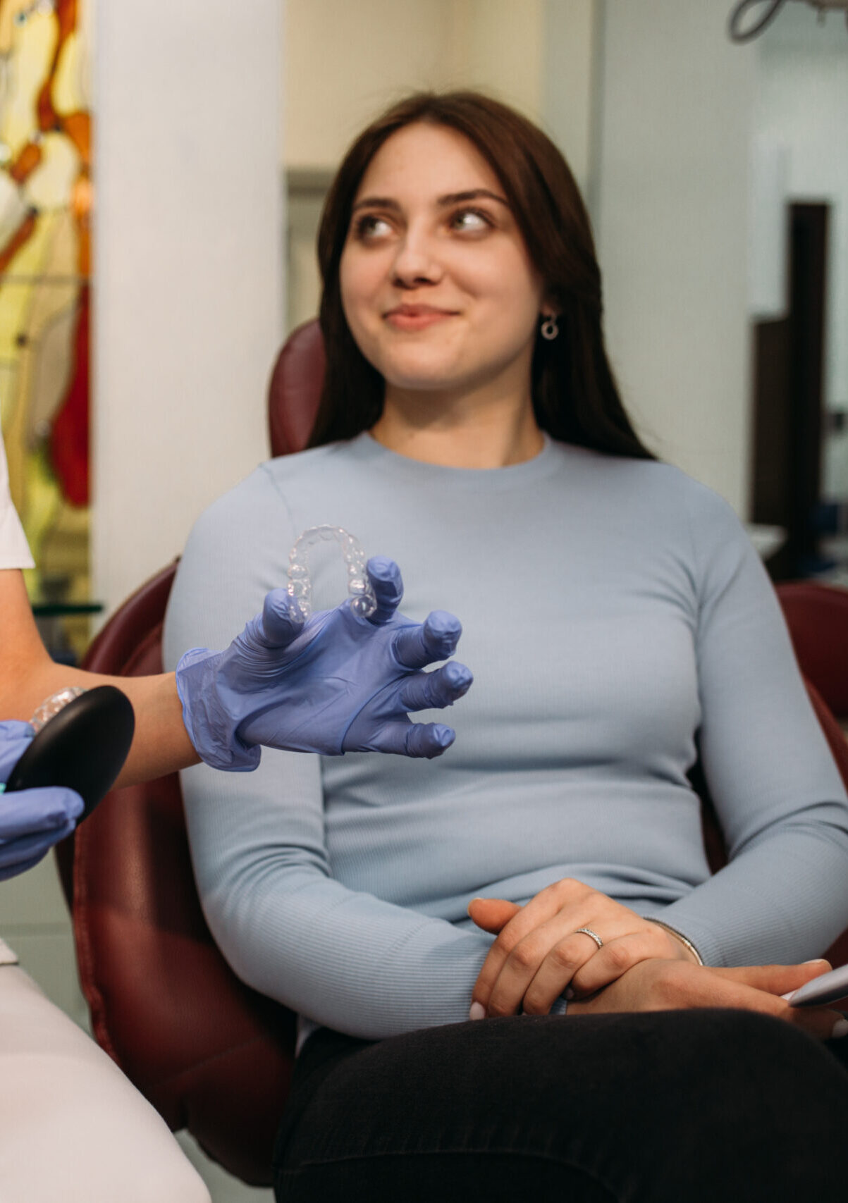 dentist shows aligners to patient in dentistry