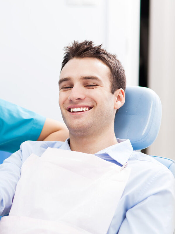 Man giving thumbs up at dentist office