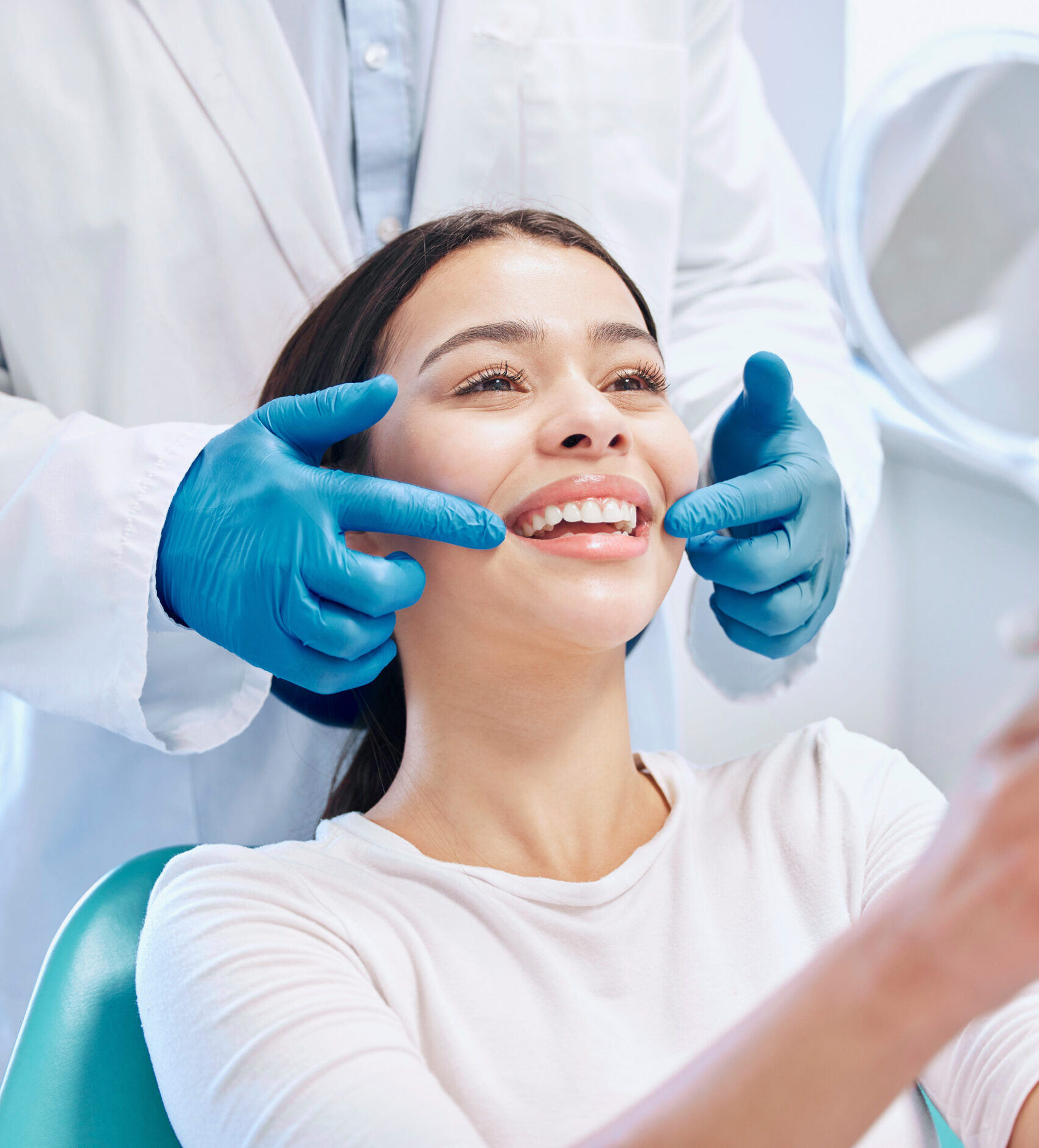 Dental consultation, mirror and woman with smile after teeth whitening, service or mouth care. Healthcare, dentistry and happy female patient with orthodontist for oral hygiene, wellness and cleaning.