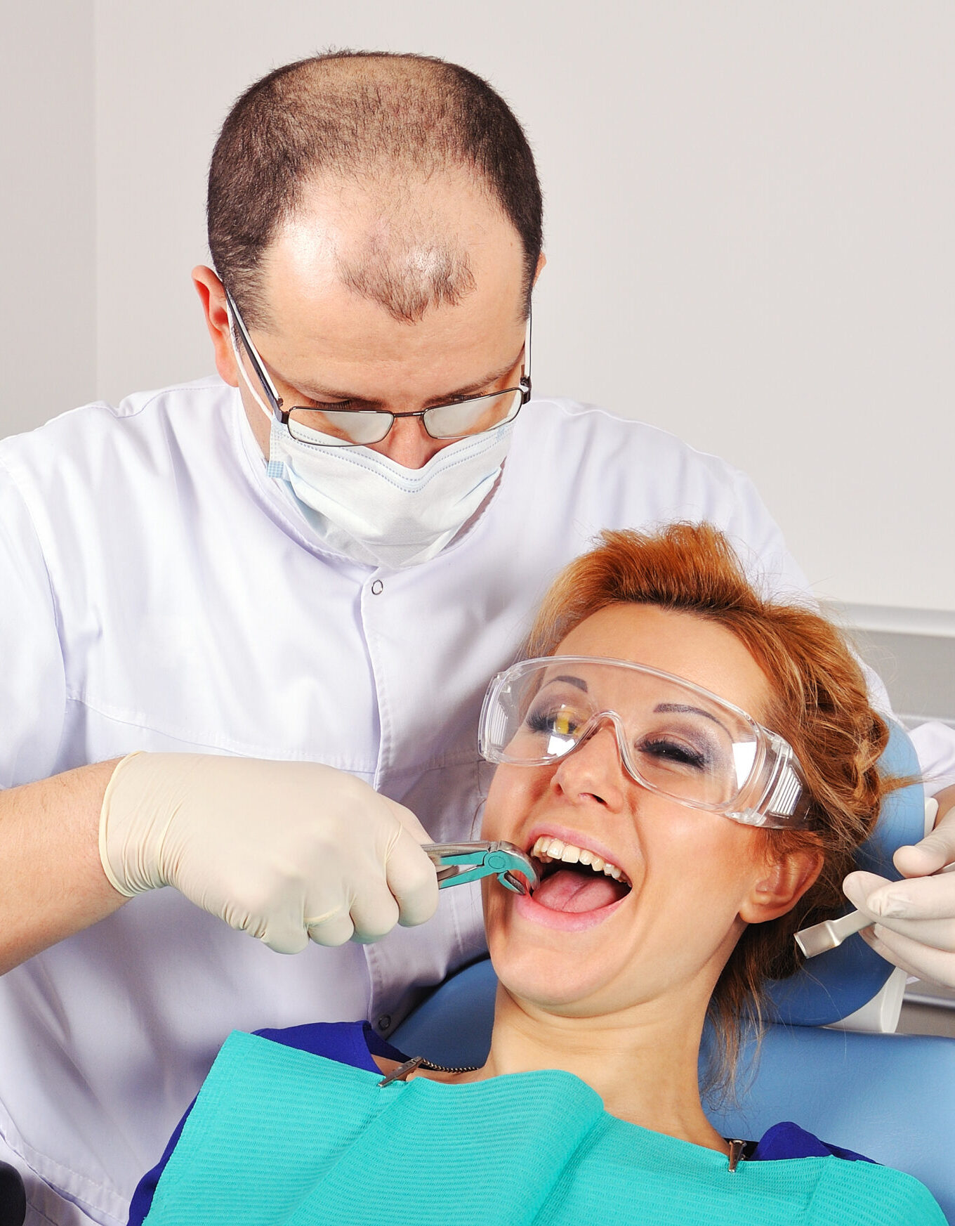 dentist removes the tooth beautiful girl