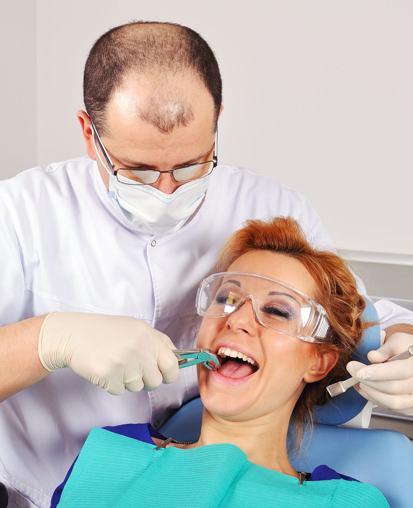 dentist removes the tooth beautiful girl
