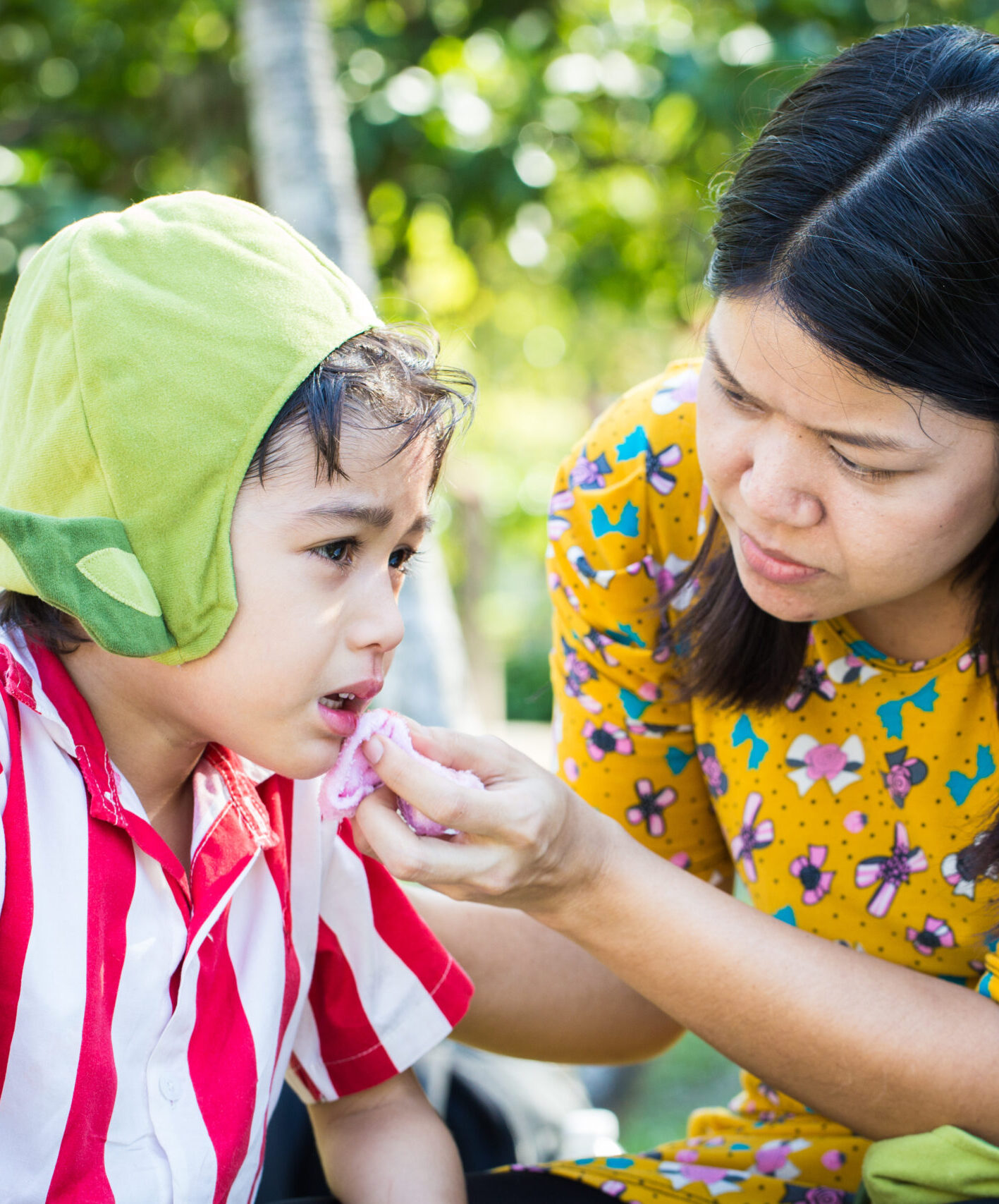 Little boy Bleeding at the mouth and mother help first aid to him