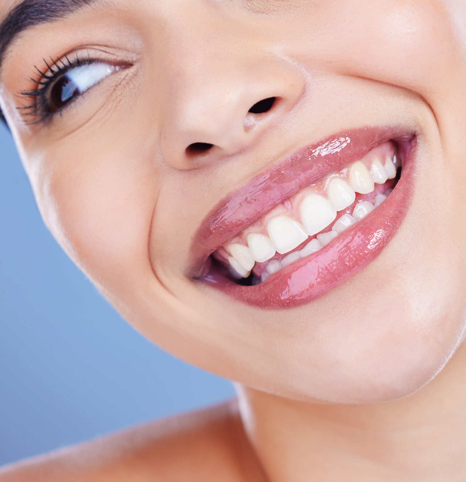 Dental, results and woman with mouth in studio for oral hygiene, healthcare and mouth wellness. Happy, client and closeup with smile for teeth whitening, cosmetics and treatment on blue background.