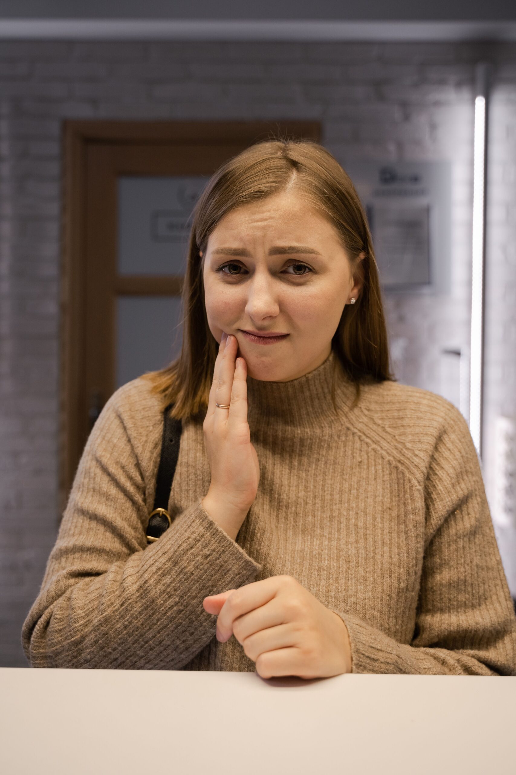 Adult woman with toothache at dental clinic in Reno NV