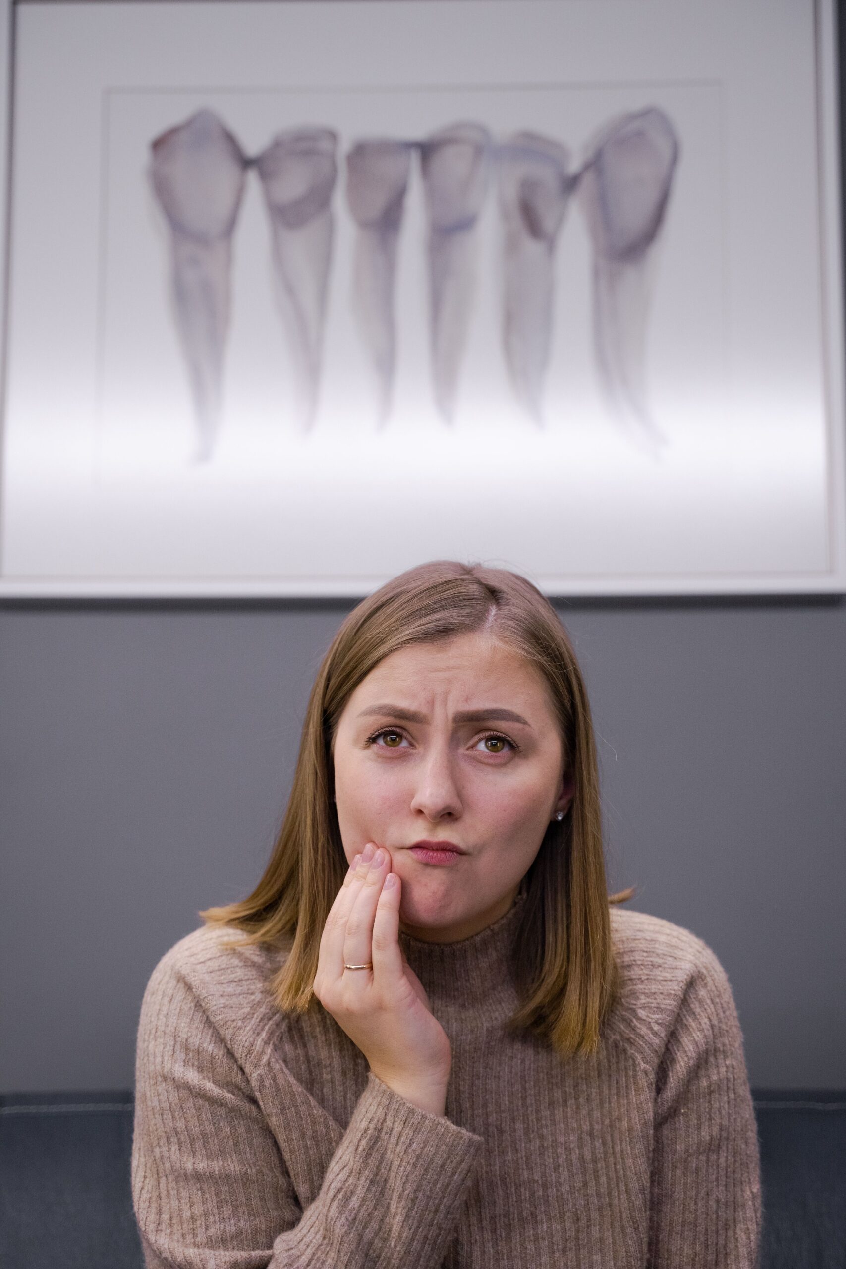 Adult woman experiencing dental pain at dentist office in Reno NV