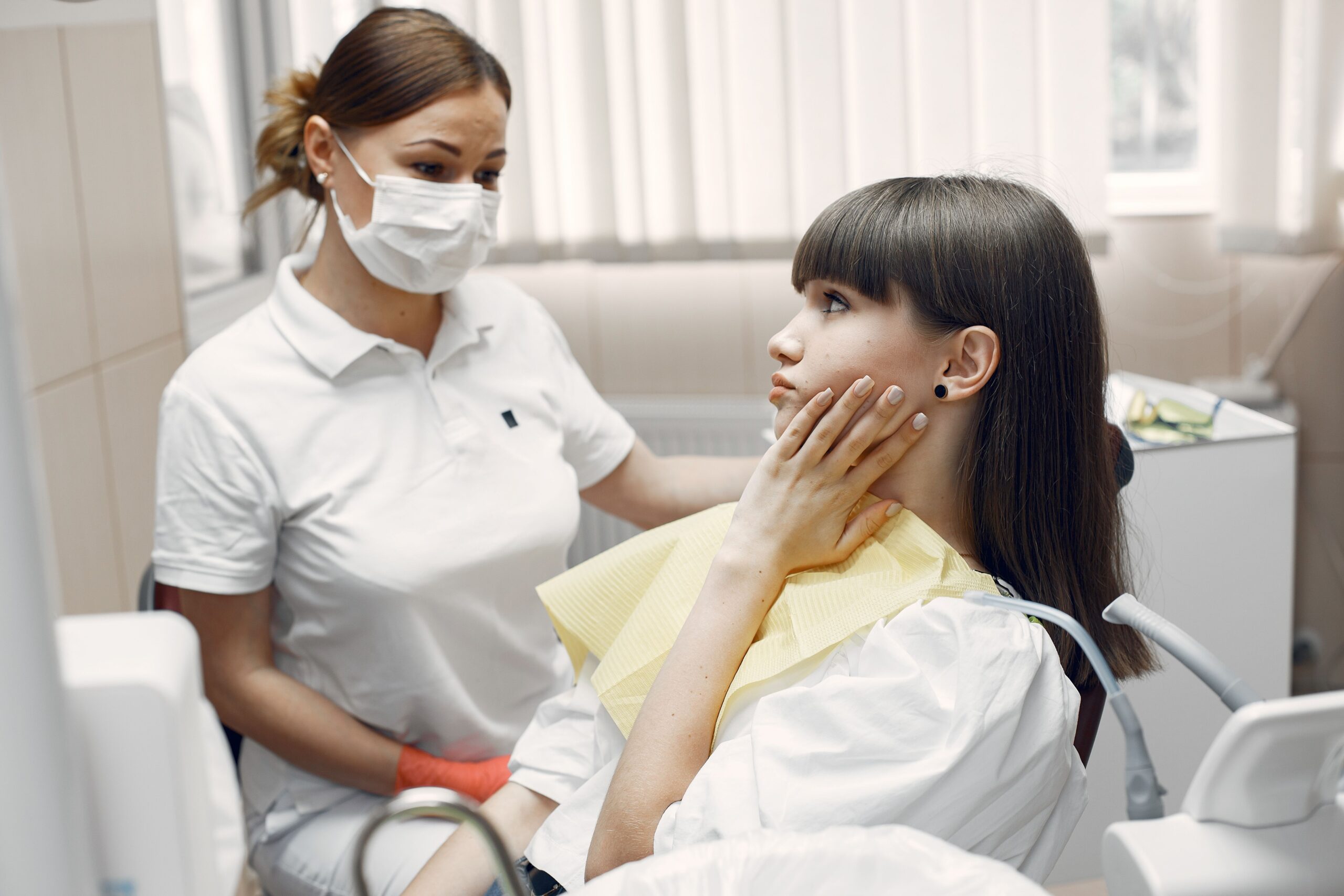 Dentist examining adult patient with toothache at White Pine Family Dental Reno